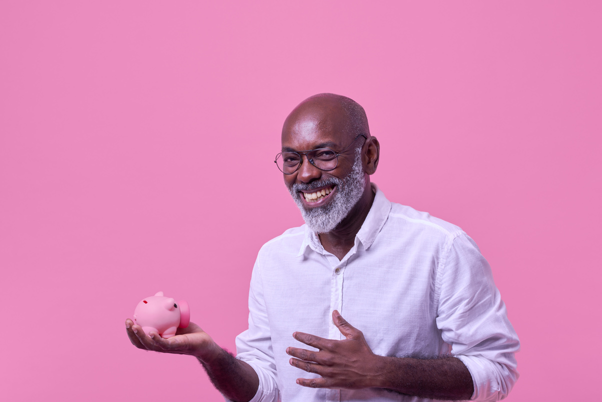 Bold & Punchy Headshots Portrait of Man Holding Piggy Bank